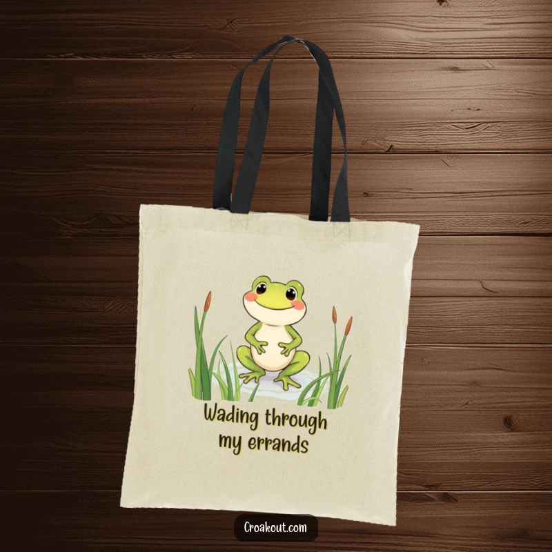 Funny frog tote bag showing a beaming character wading through reeds, designed for carrying items with a side of pure, happy humor.